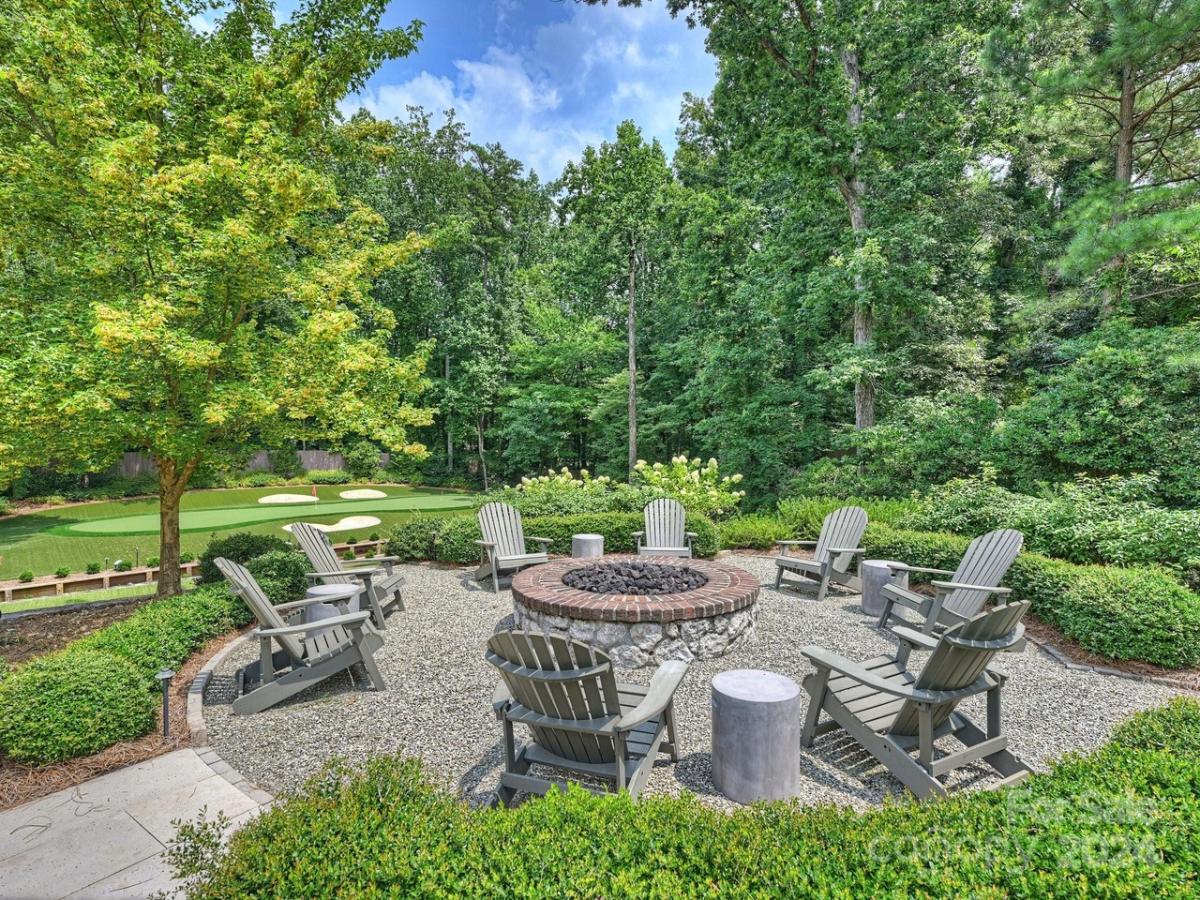 Fire pit with chairs and plants.