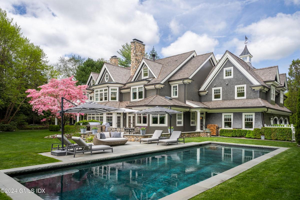 Rear view of the mansion with a pool.