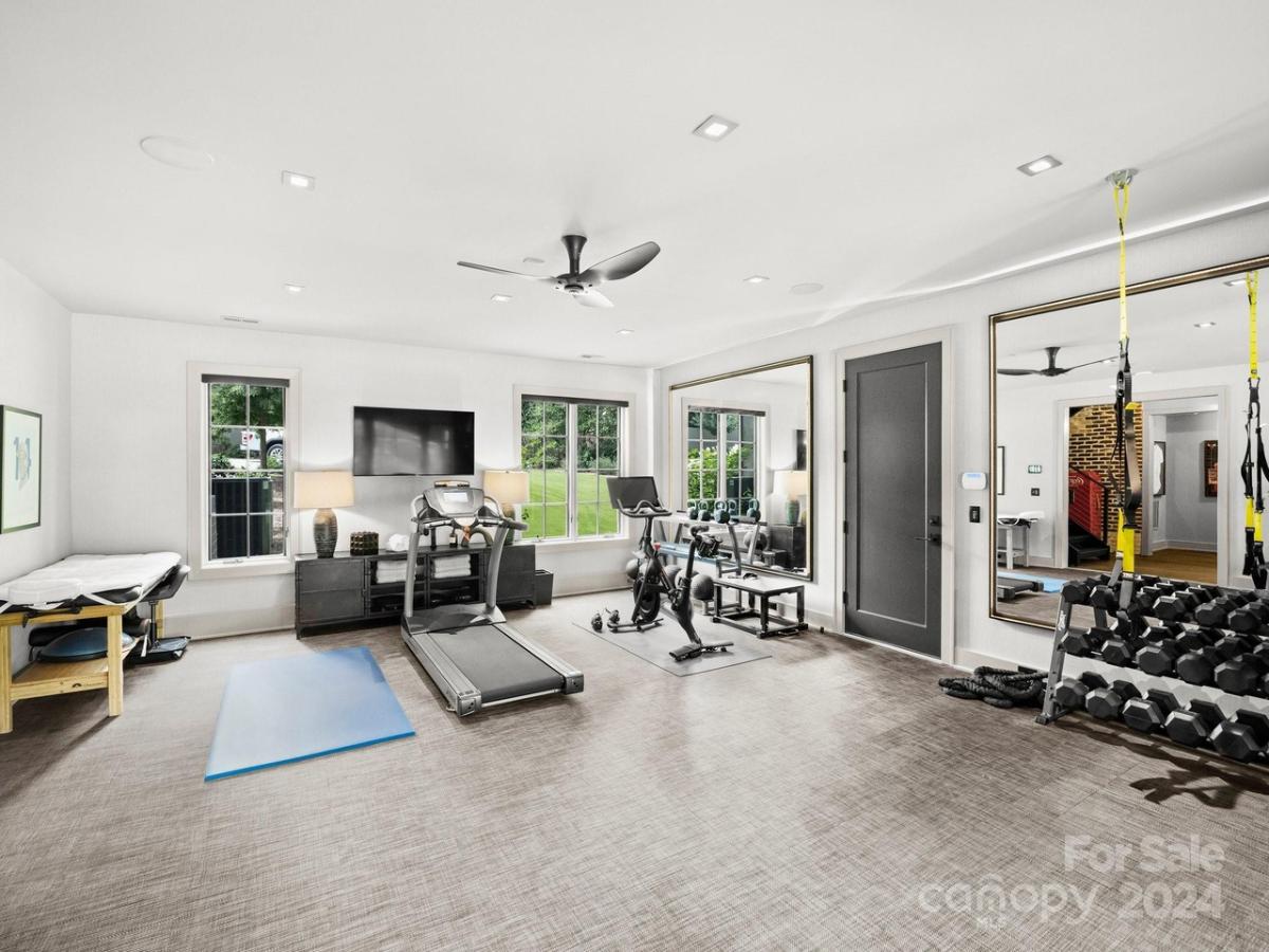 Home gym with large mirrors.