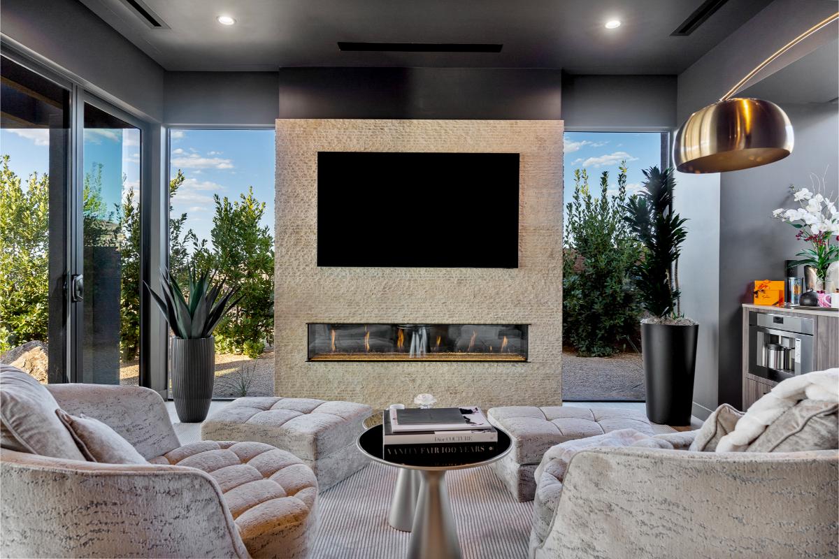 Outdoor living space with a fireplace and a bar.