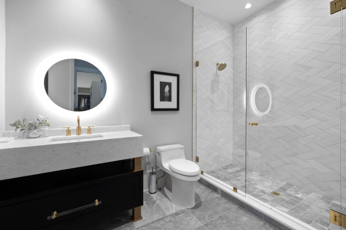 Bathroom with a sink, toilet and a walk-in shower.