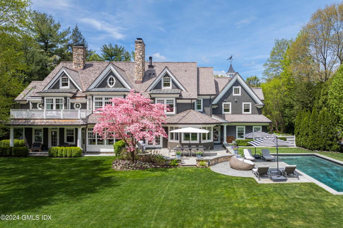 Rear view of the mansion with a pool.