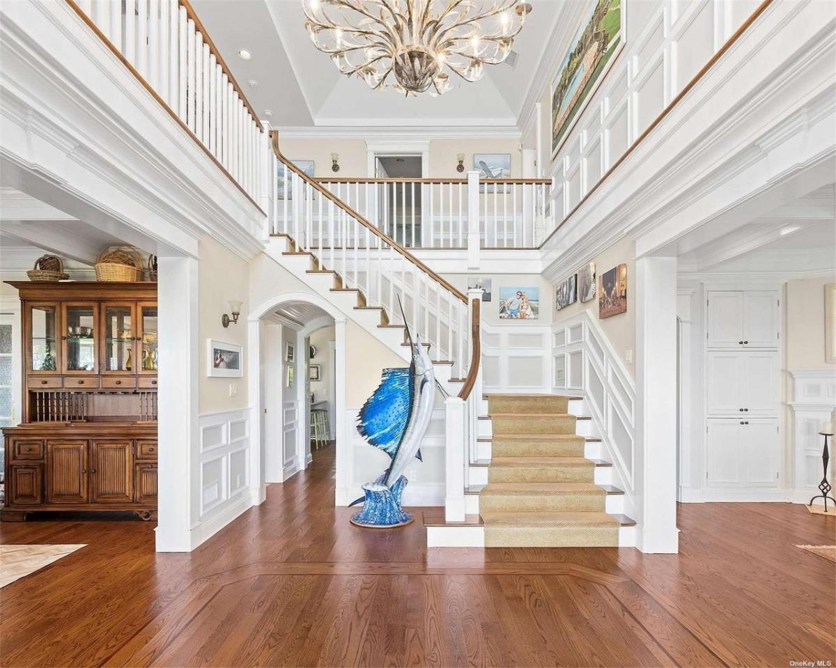 Foyer with a chandelier and staircase.