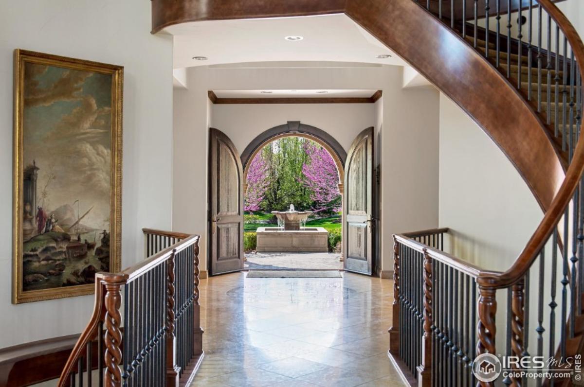 Foyer with large hardwood doors.