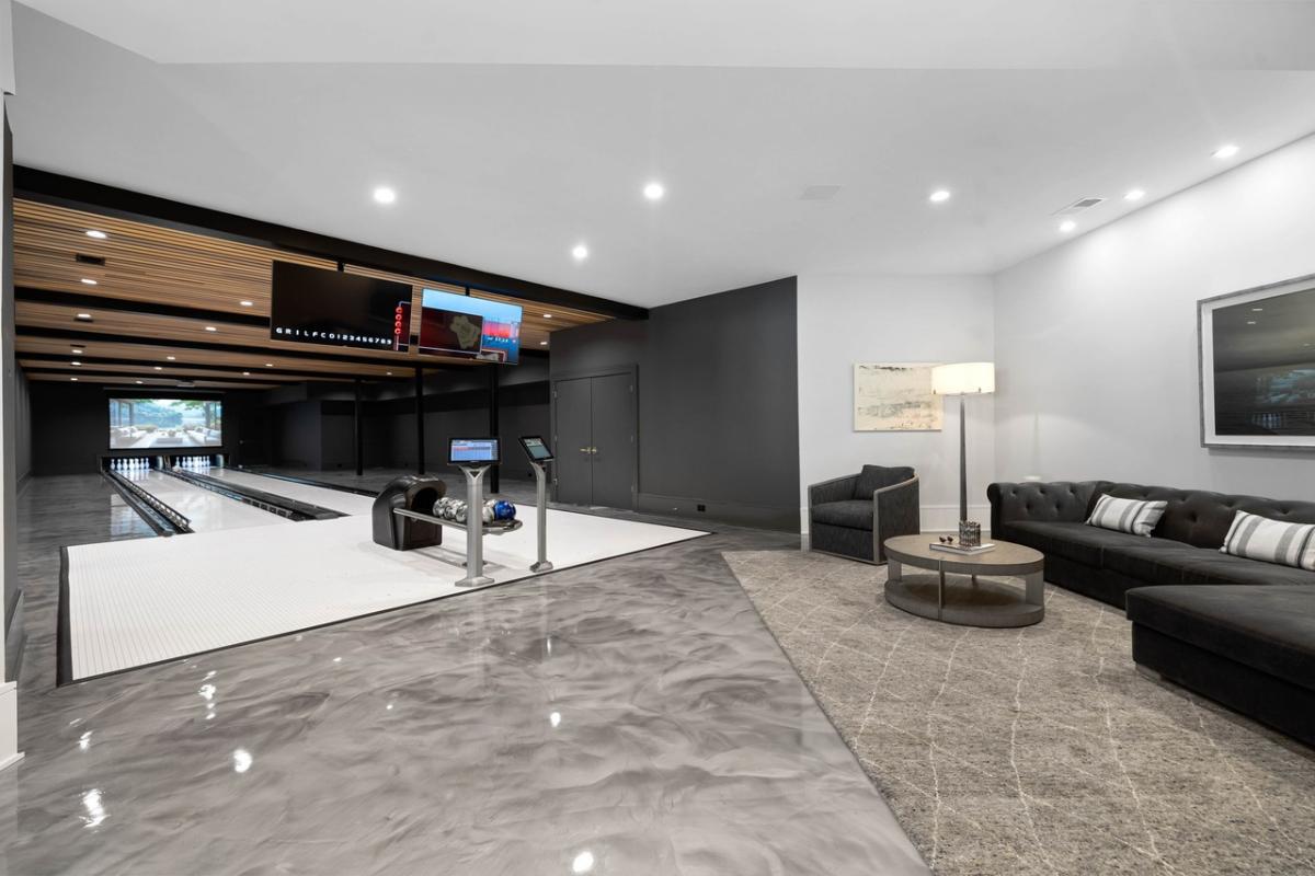 Bowling alley with a table and sofas.