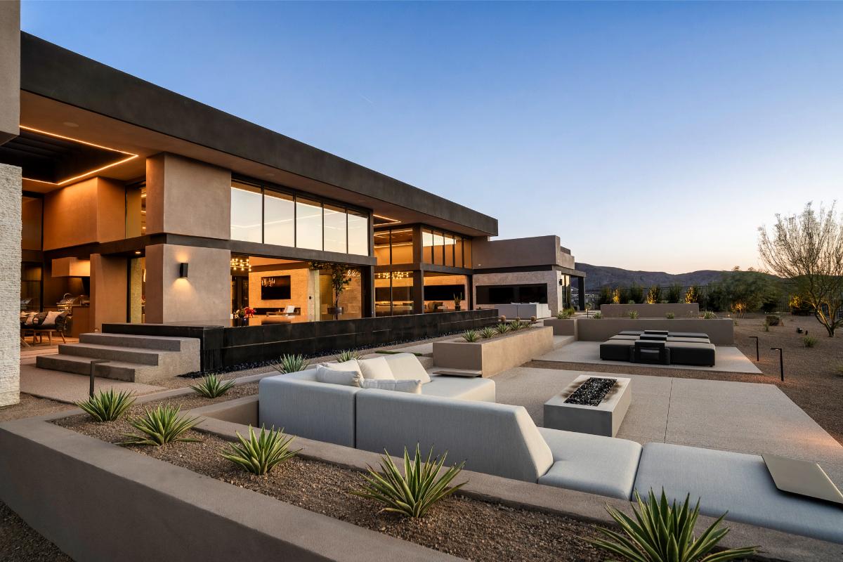Backyard of the mansion with a pool and a fire pit.