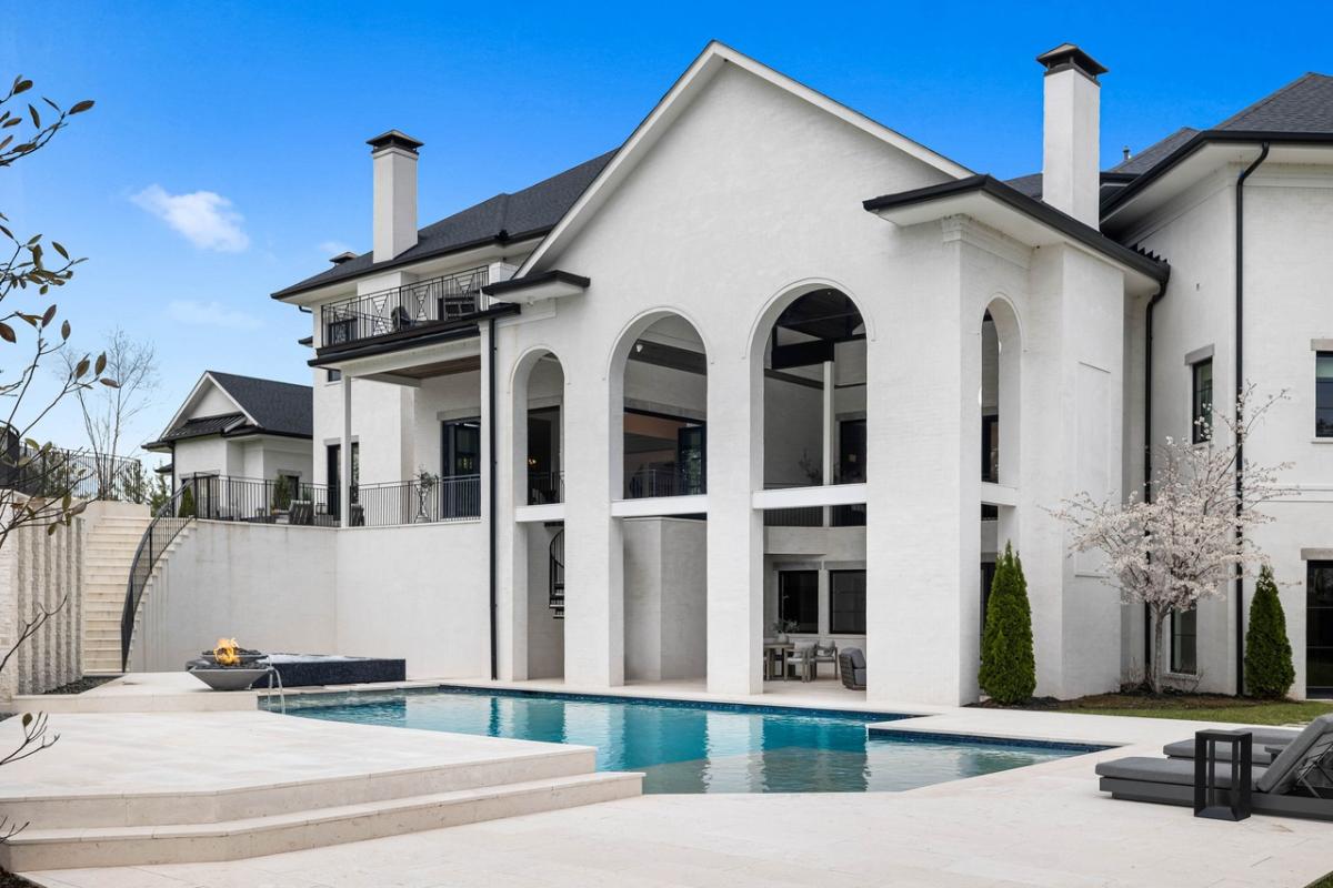 Rear view of the mansion with a pool.