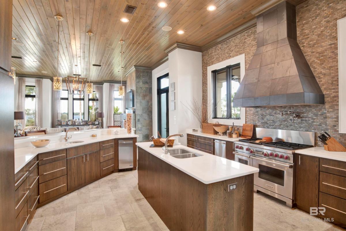 Kitchen with sinks, custom lights and custom cabinetry.