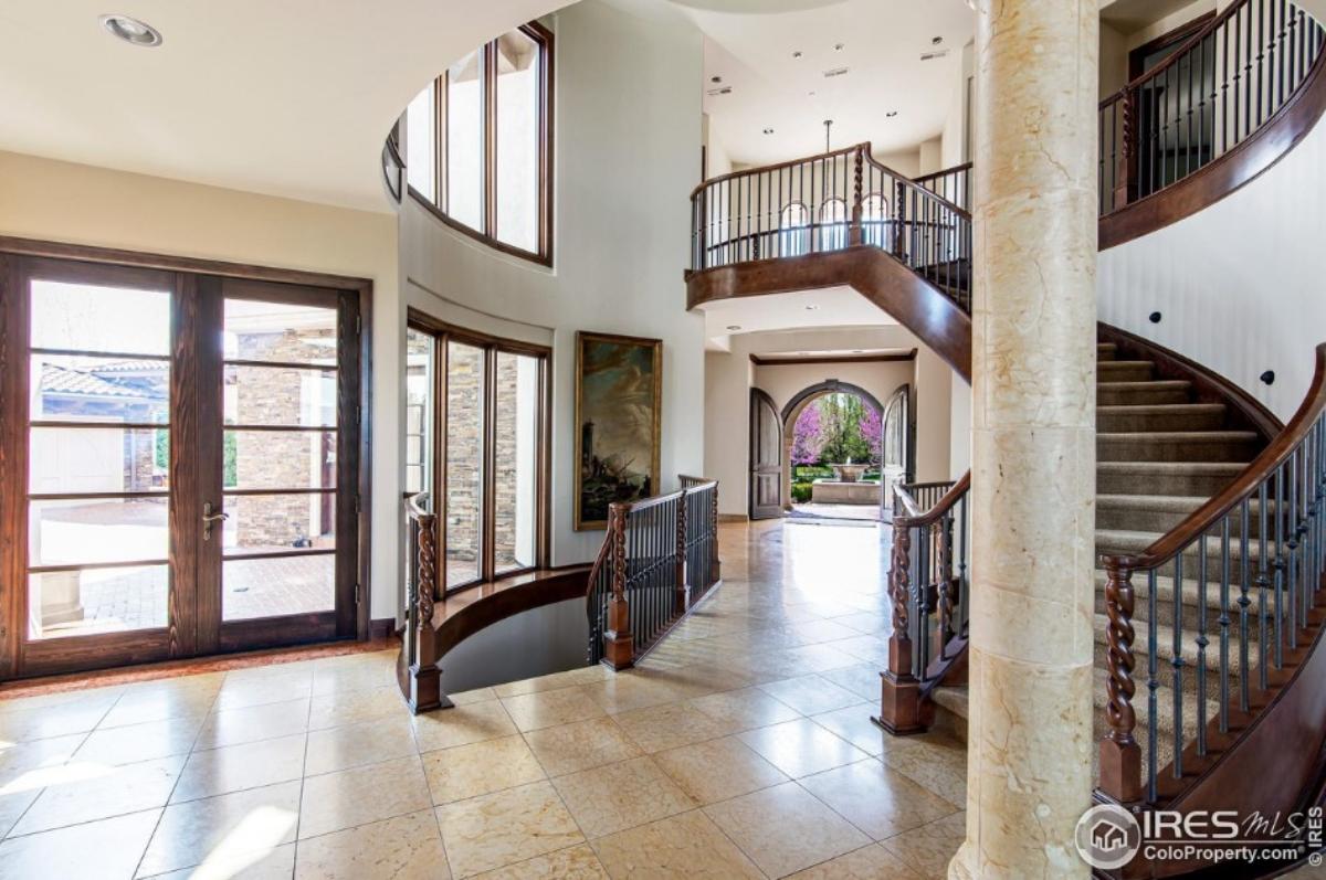 Stairs with metal and wood railings.