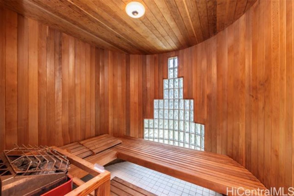 A sauna with wooden benches, walls, and ceiling.