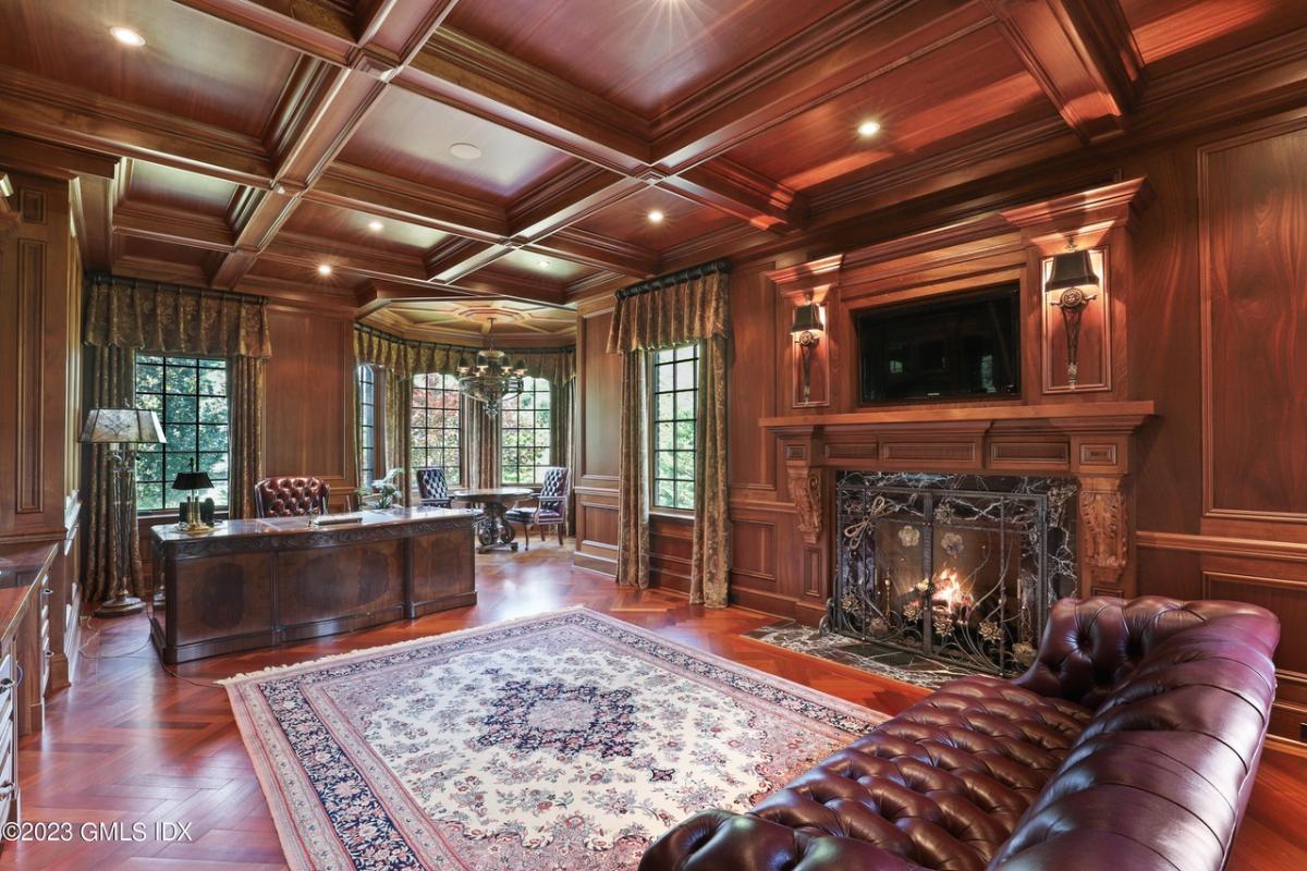 Home office with coffered ceiling and a fireplace.