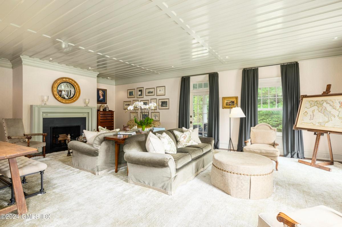 Living room with carpet flooring and a fireplace.