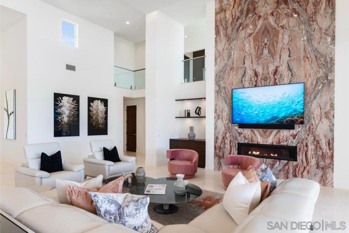 Living room with sofas, TV and a fireplace.