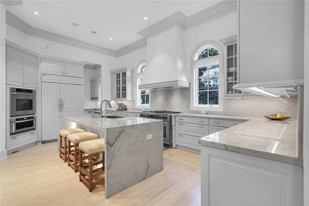 Kitchen with a large island, stainless-steel appliances and custom cabinetry.