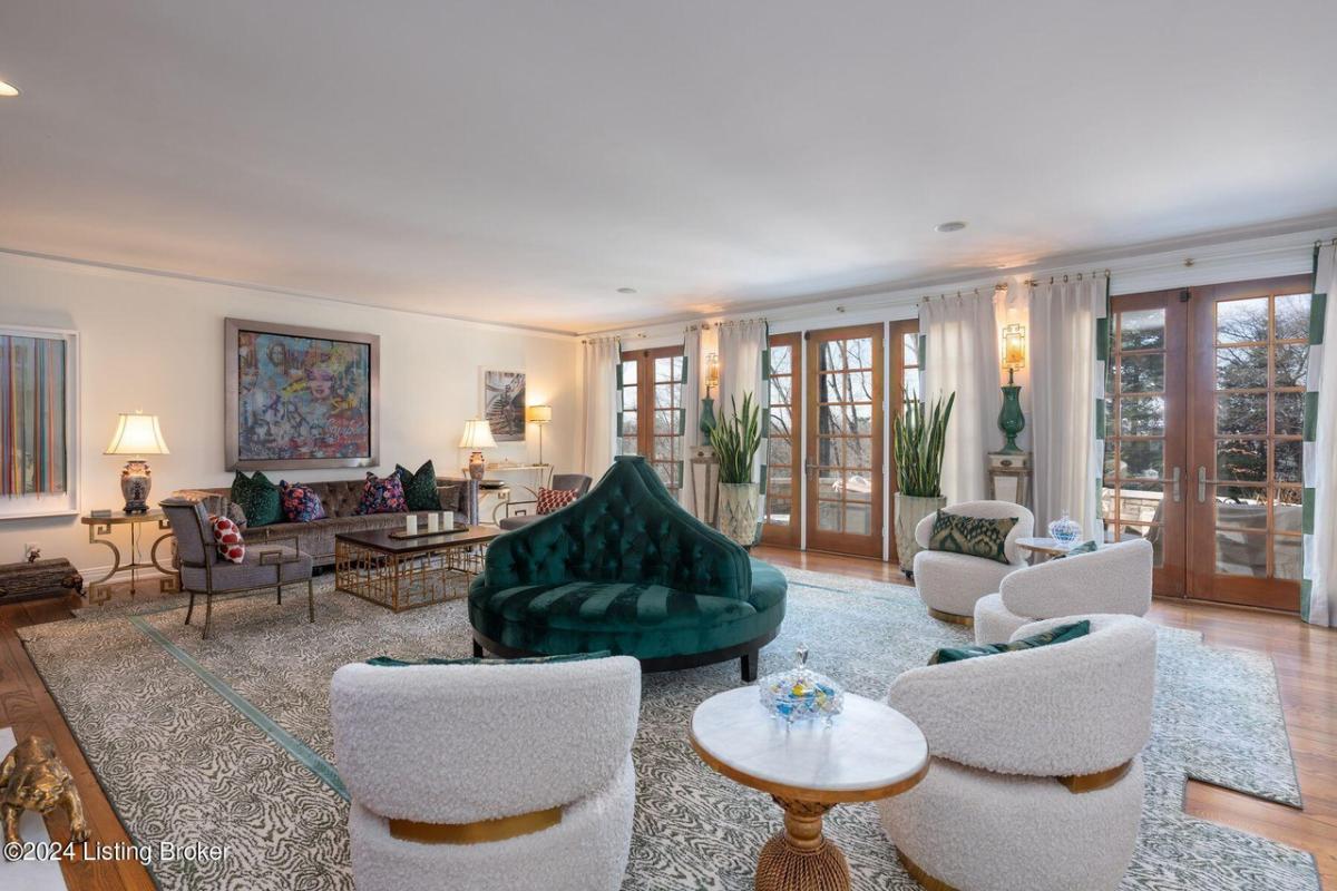 Living room with tables, chairs and glass doors.