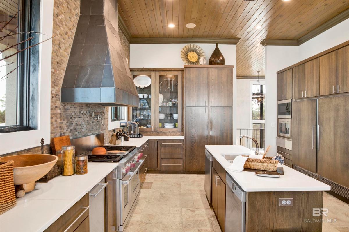 Kitchen with sinks, custom lights and custom cabinetry.