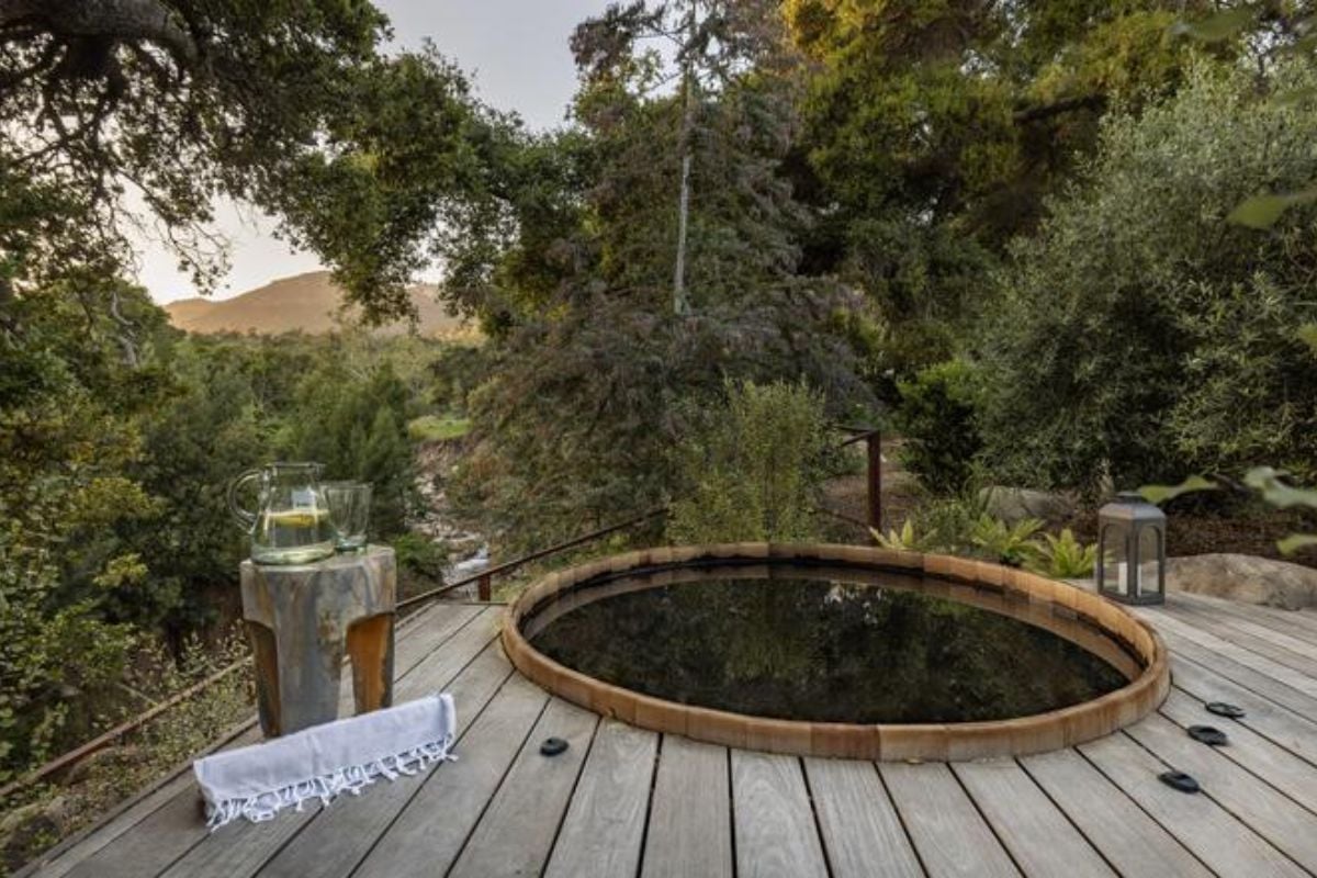 A wooden deck with a mini pool.