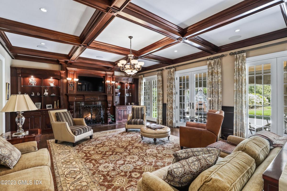 Family room with coffered ceiling and a fireplace.