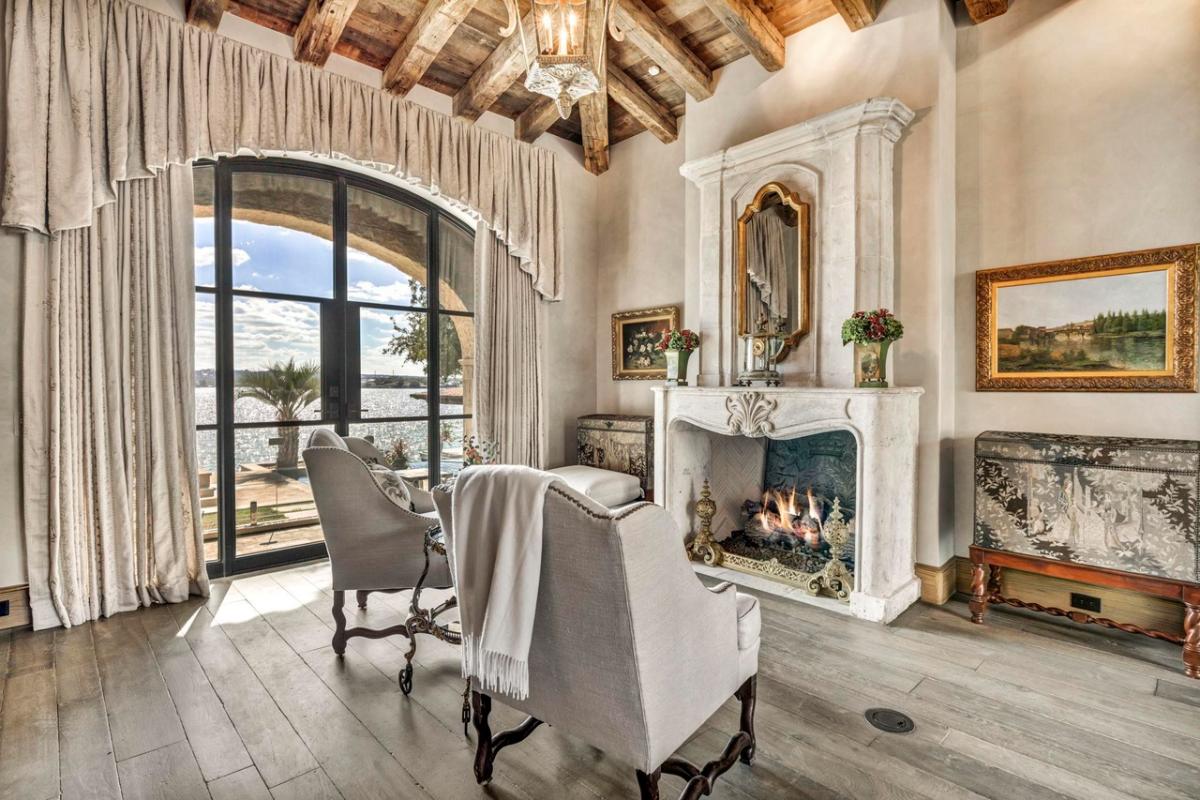 Sitting area with a fireplace and glass doors.