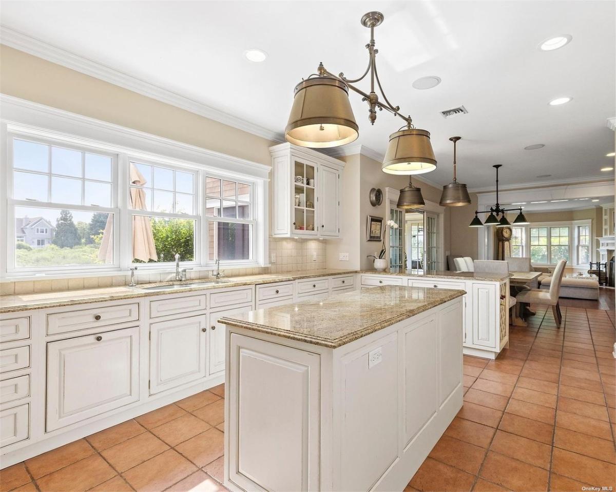Kitchen with a large island, granite countertops and custom cabinetry.