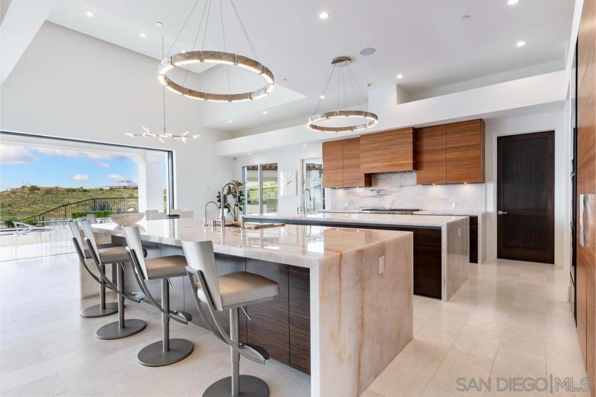 Kitchen with large islands, Onyx stone countertops and custom lighting.
