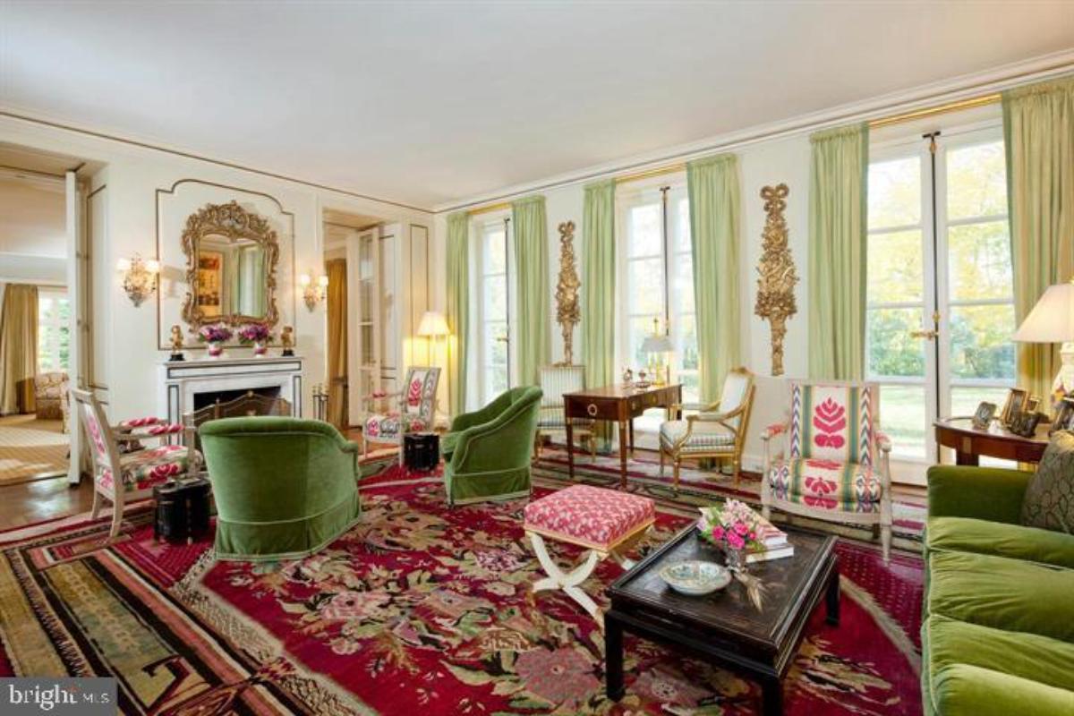 Living room with a fireplace and glass windows.