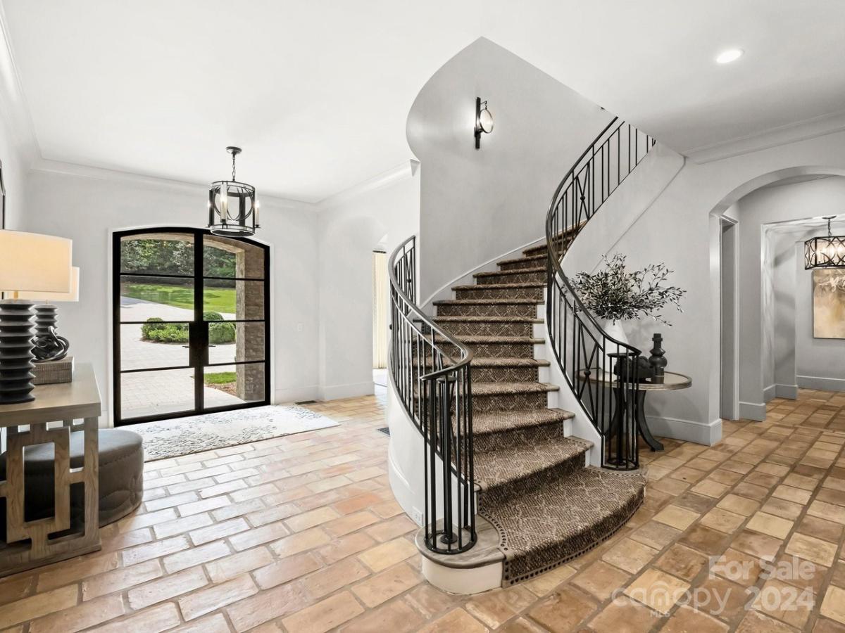 Foyer with glass door and stairs.