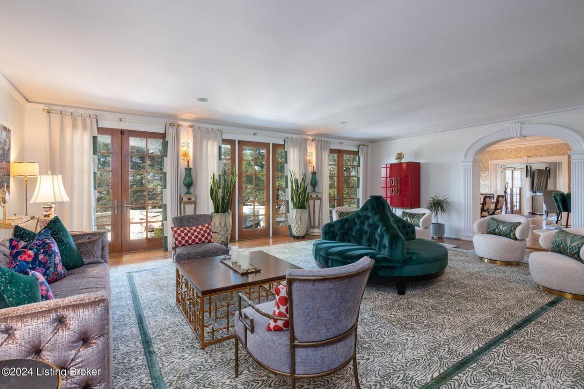 Living room with tables, chairs and glass doors.