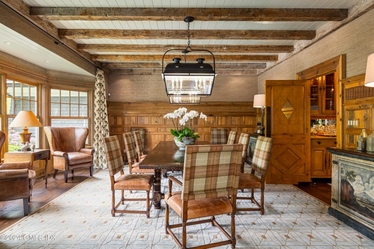 Dining room with hardwood floors and open beam ceiling.