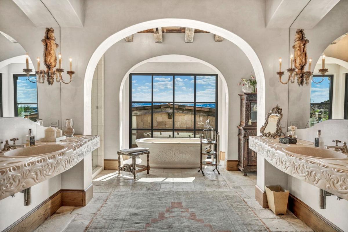 Bathroom with dual sinks and a soaking tub.