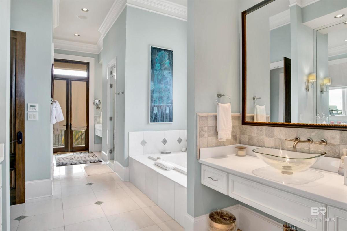 Bathroom with a sink and a soaking tub.
