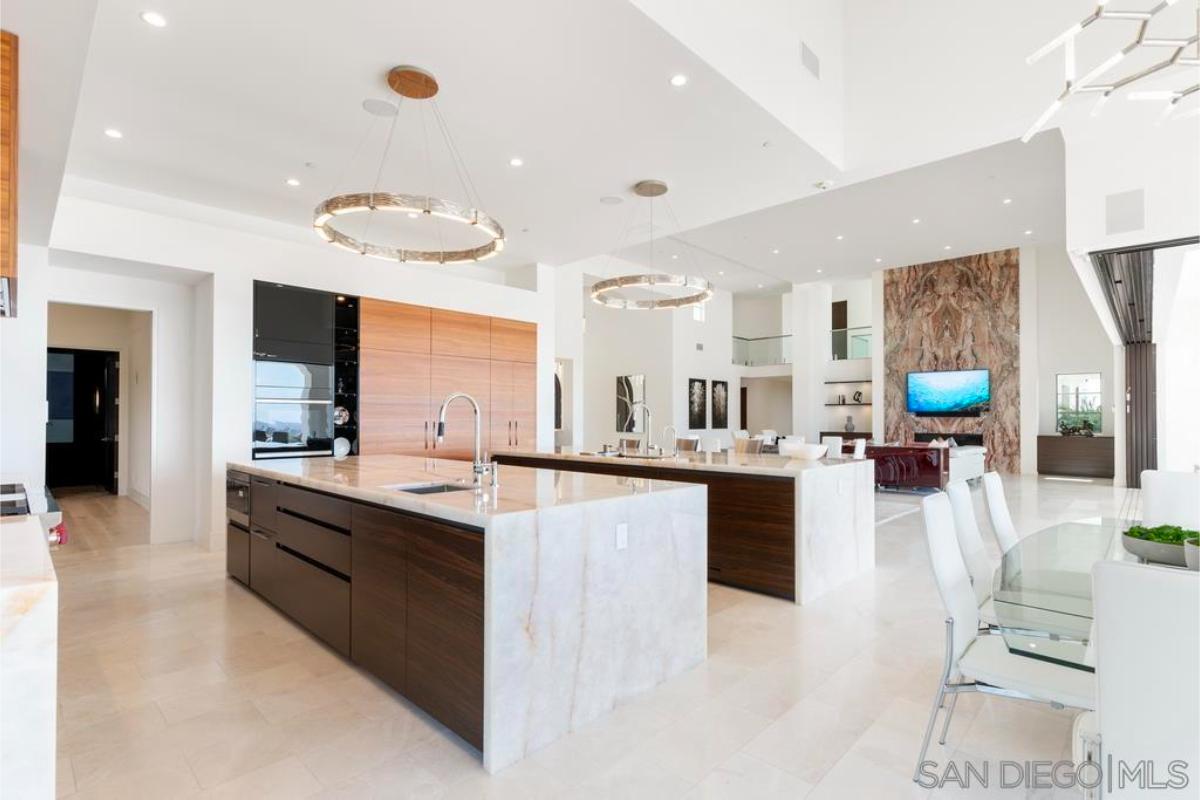Kitchen with large islands, Onyx stone countertops and custom lighting.