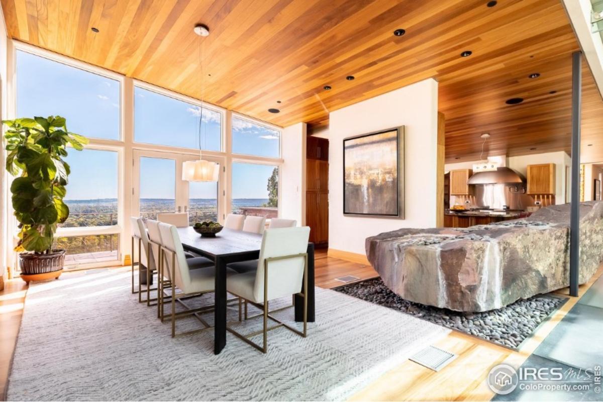 Dining room with hardwood floors and a large rug.