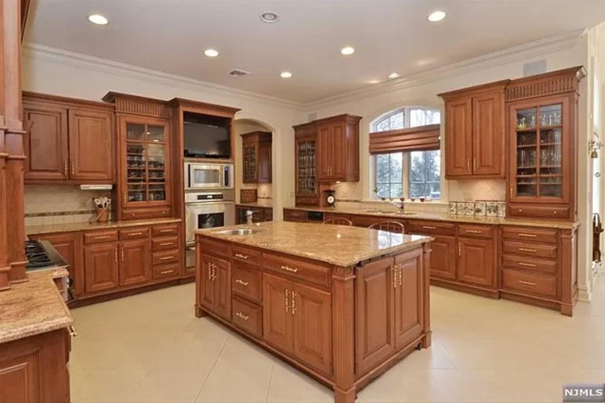 Kitchen with a large island, custom lighting and custom cabinetry.