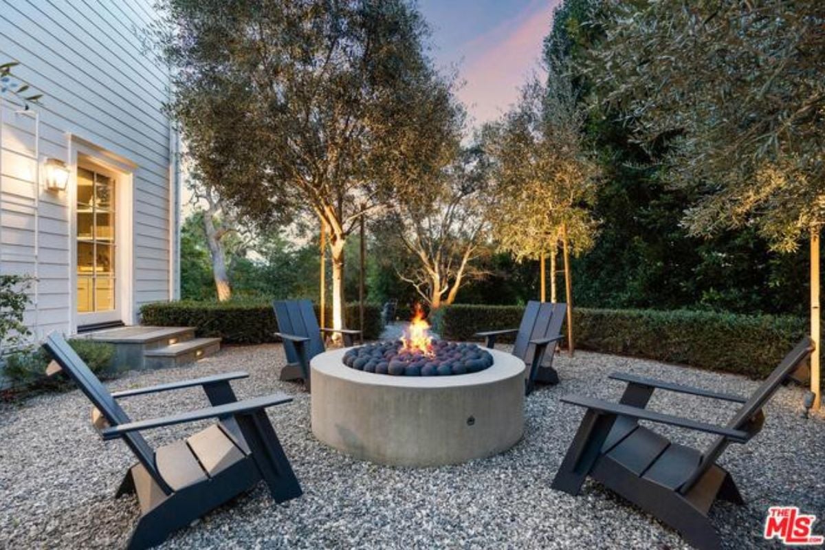 A firepit surrounded by chairs.