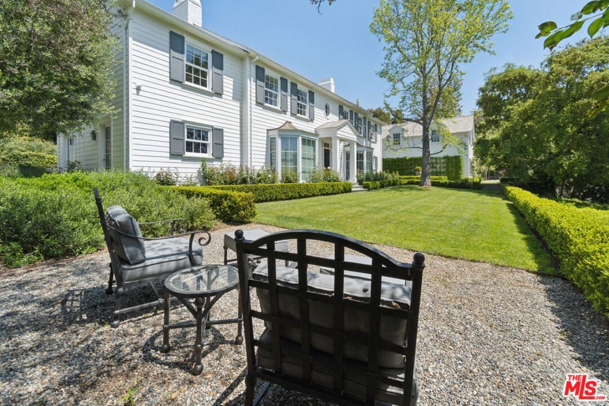 A patio with chairs and a coffee table.