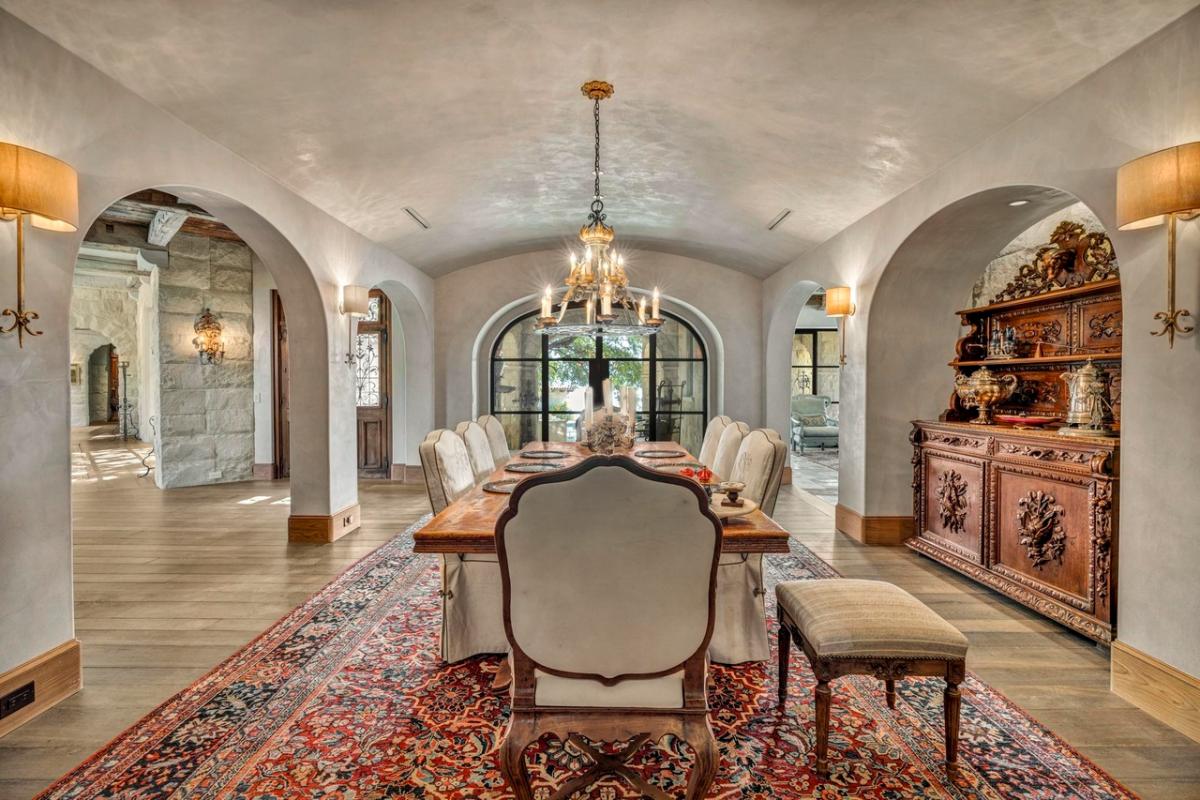 Dining room with a chandelier and hardwood floors.
