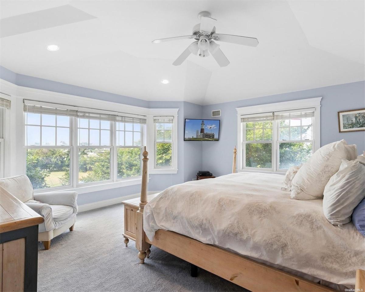 Bedroom with carpet floors and glass windows.