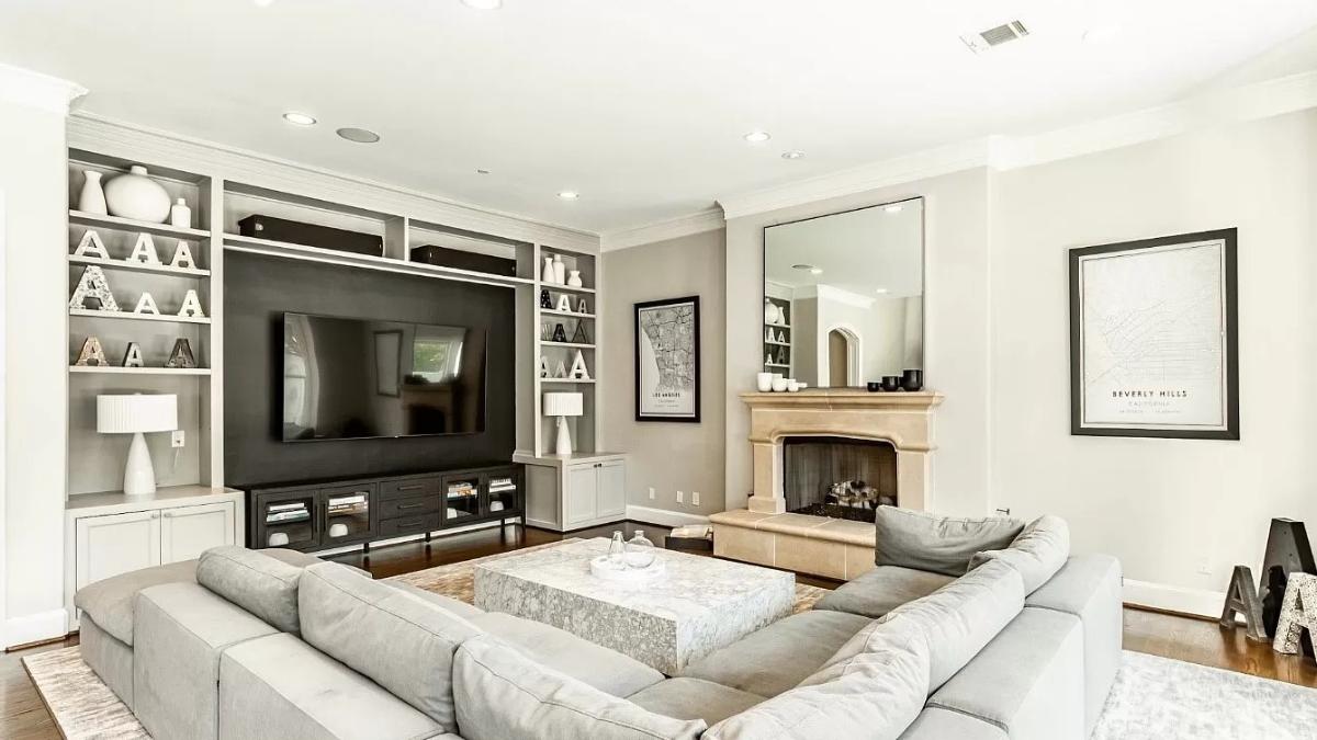 Family room with custom lighting and a TV.