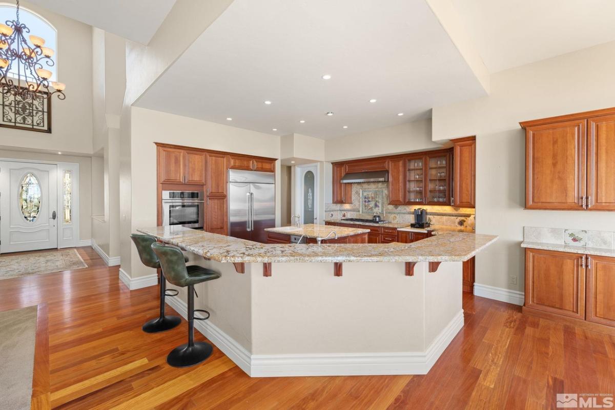 Kitchen with stainless-steel appliances, a large island and custom cabinetry.