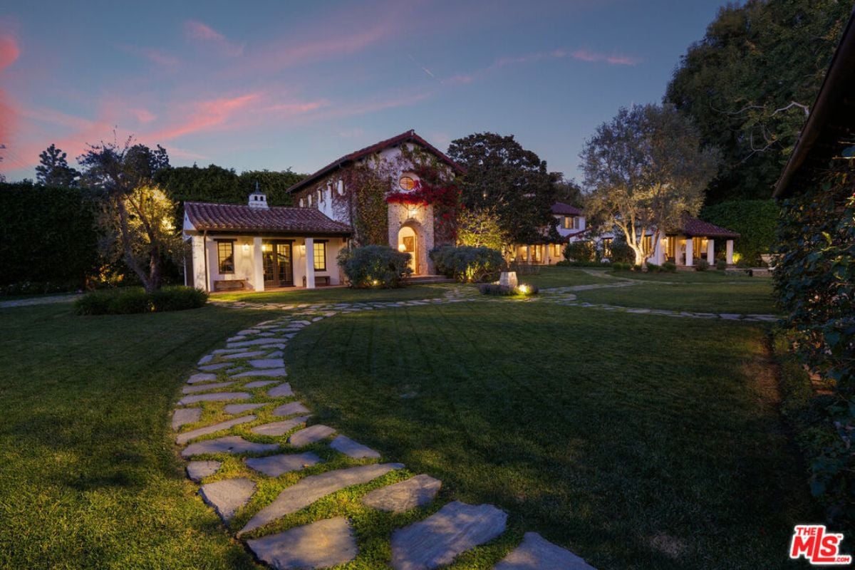 A stone walkway surrounded by green grass.
