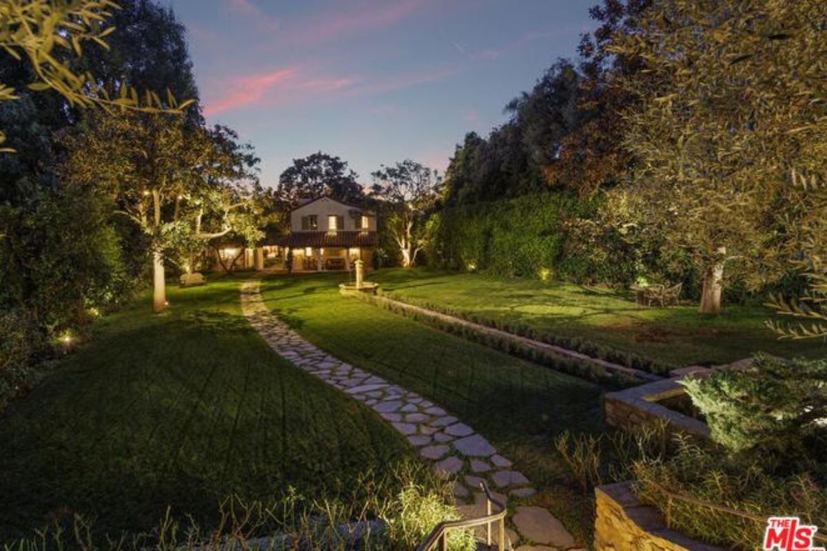 A stone walkway surrounded by green grass.
