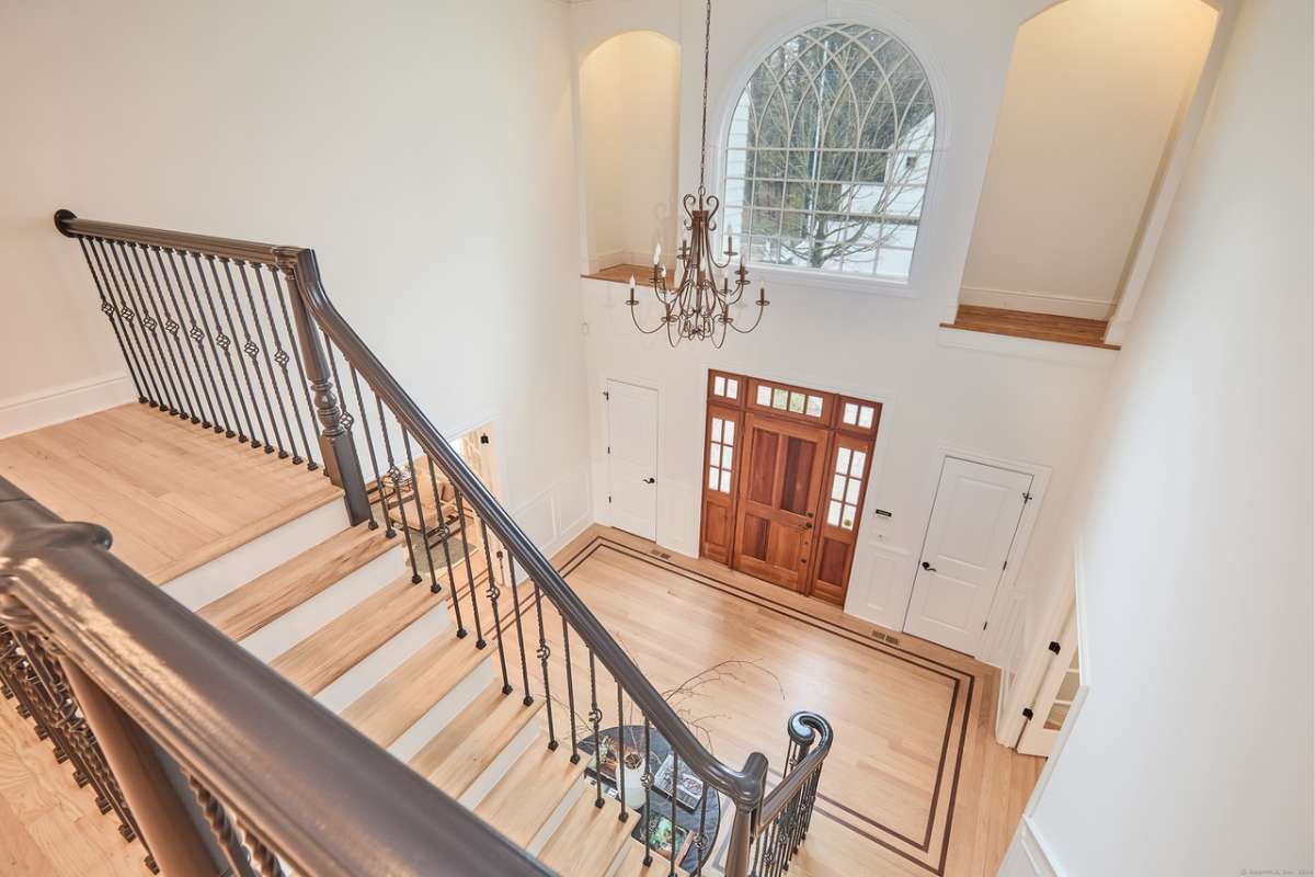 A staircase with wooden steps and a metal handrail.
