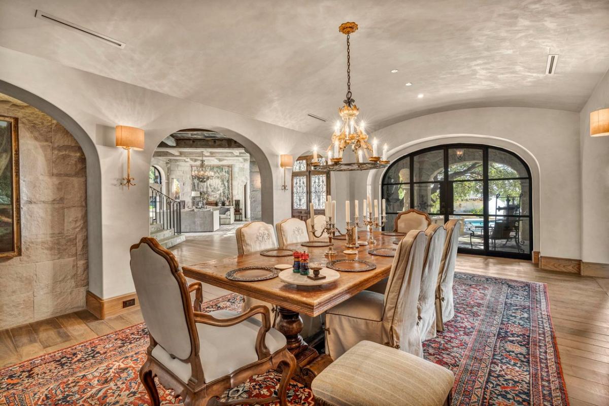 Dining room with a chandelier and hardwood floors.