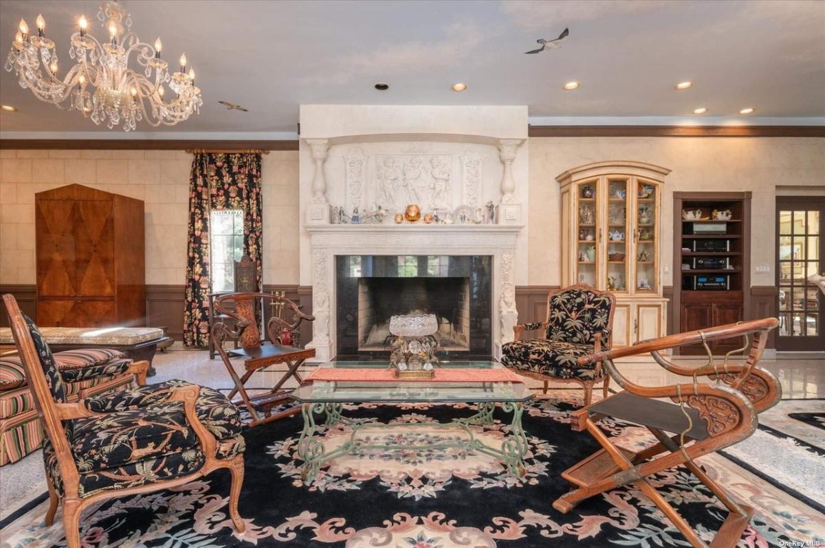 Sitting area with a chandelier and a fireplace.