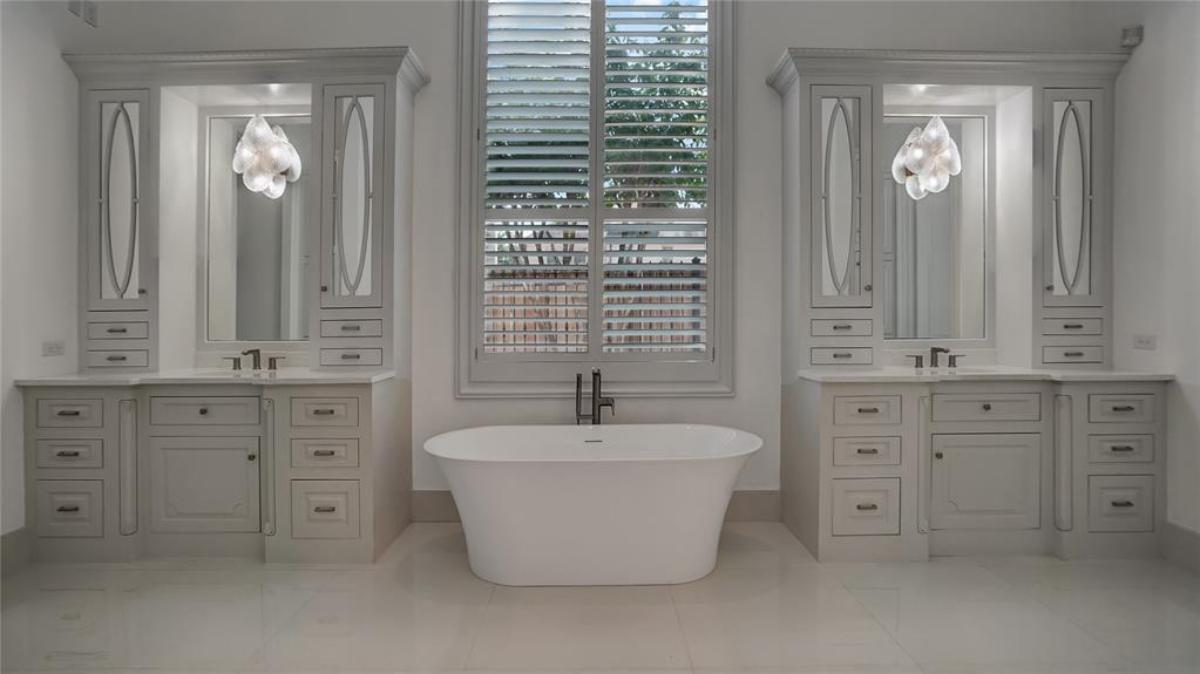 Bathroom with dual sink and a soaking tub.