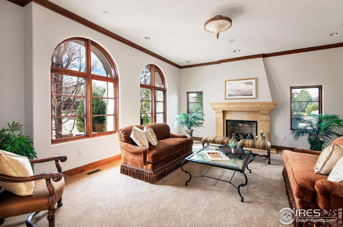 Living room with carpet flooring and a fireplace.