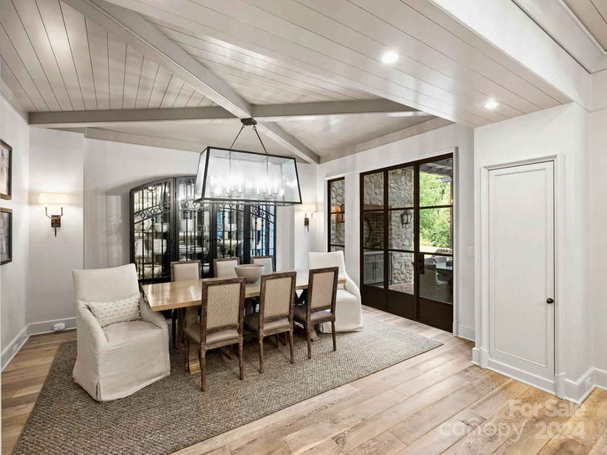 Dining room with a chandelier and hardwood floors.
