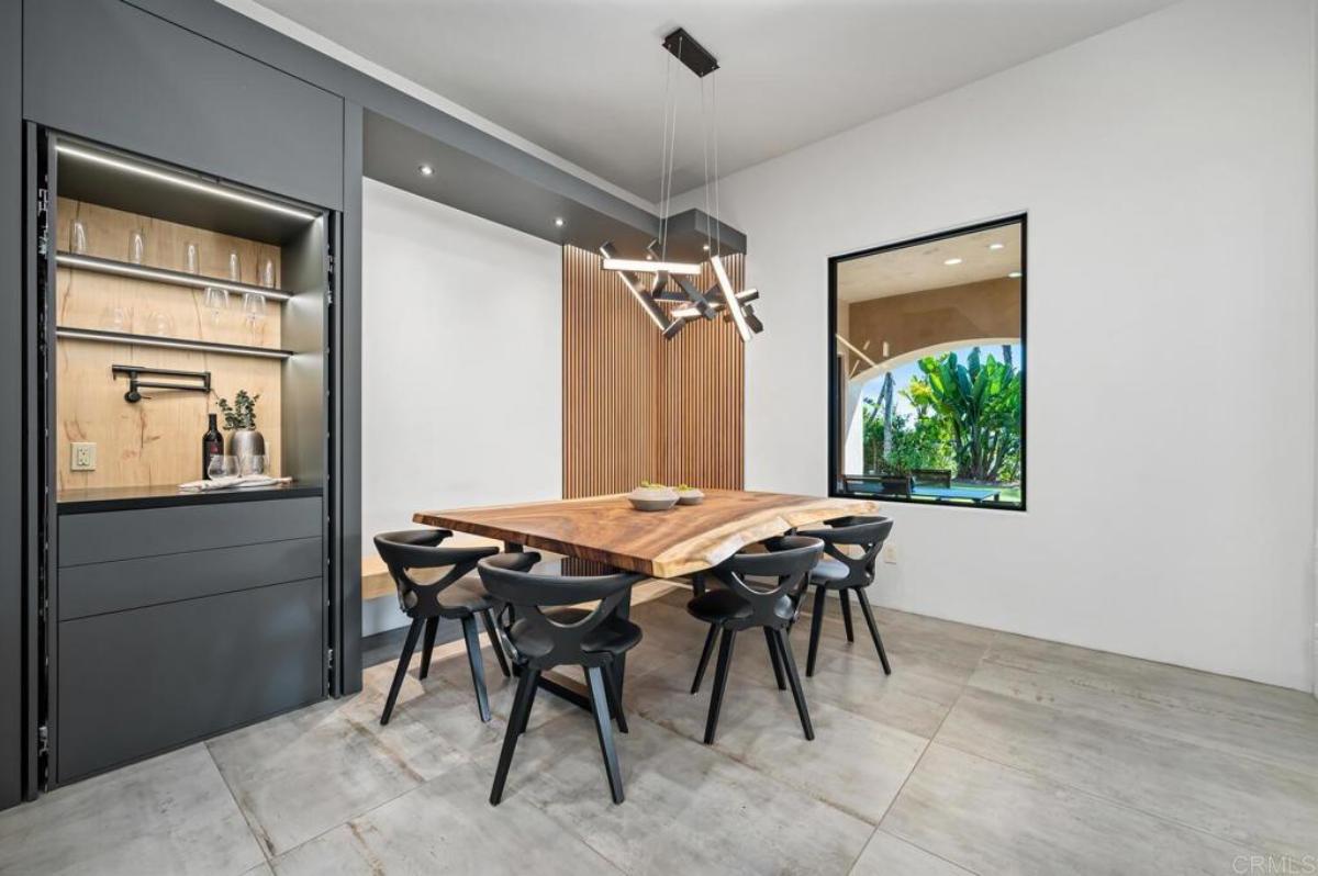 Breakfast nook with a large wood table and chairs.