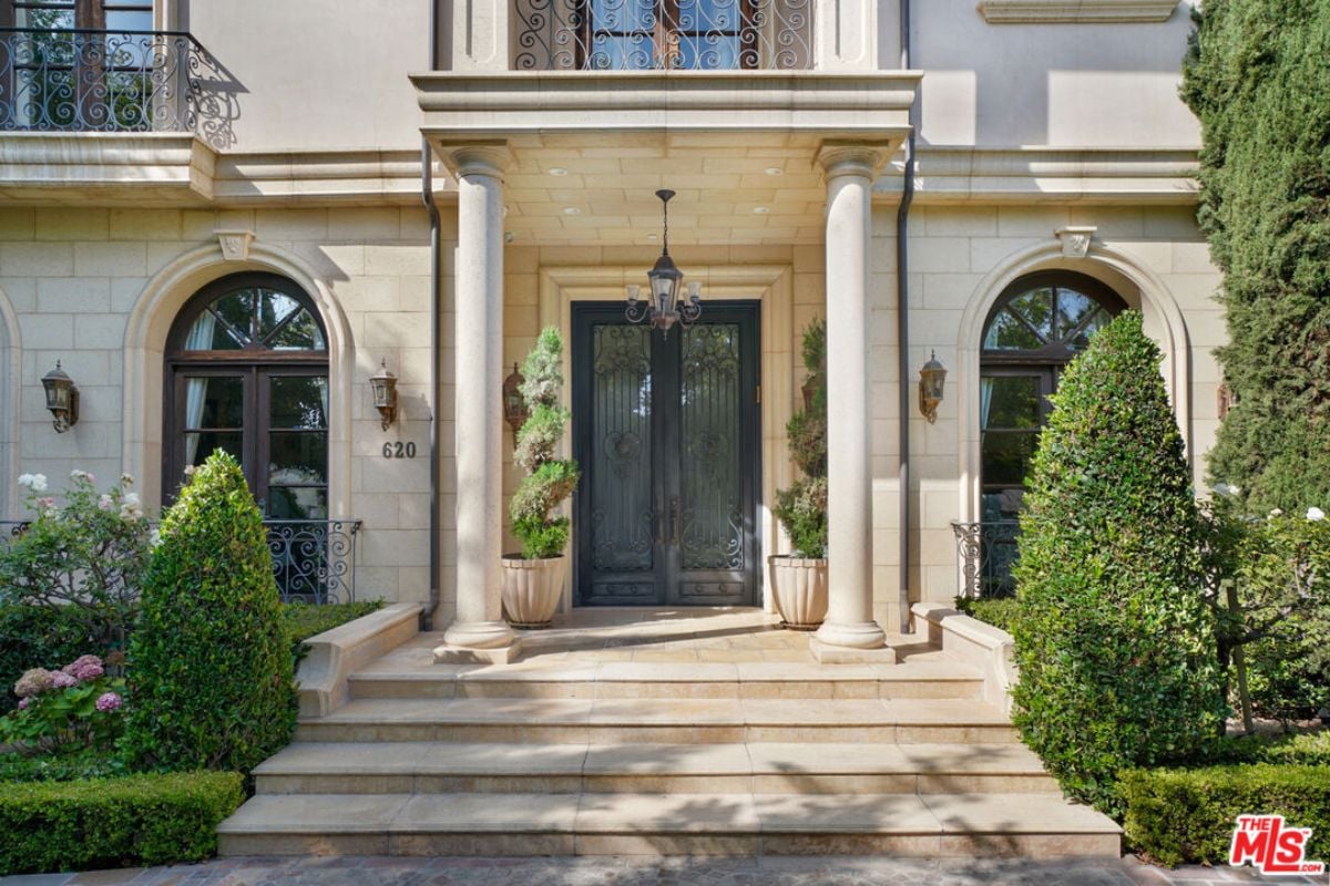 A front entry with a lamp and plants.